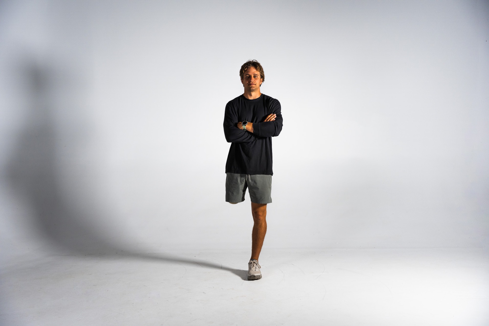 Lucas Arsenault standing on one leg with his arms crossed